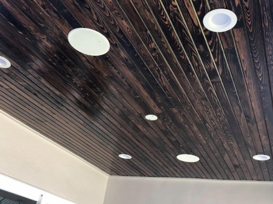 In-ceiling speakers installed in a patio wood ceiling